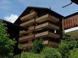 a building with balconies on the side of it at Superb apartment with views of the Alps in Bellwald