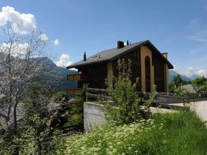 a house on the side of a hill at Superb apartment with views of the Alps in Bellwald