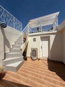 a house with a staircase with a door and a stair at Riad 052 in Marrakesh