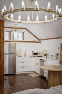a kitchen with white cabinets and a stainless steel refrigerator at Chic Retreat on Broadway Street in Grove City