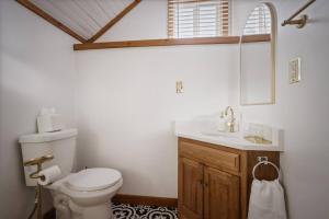 a bathroom with a toilet and a sink at Chic Retreat on Broadway Street in Grove City +14 photos