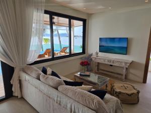 a living room with a couch and a large window at Casa By The Sea in Bangrak Beach