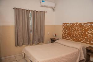 a bedroom with a bed and a window at El Rosedal Cataratas in Puerto Iguazú +117 photos