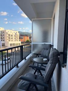 a balcony with a couch and a table on a balcony at Astera 3 in Vrnjci