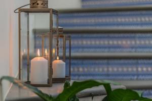 a candle holder with two candles in front of a mirror at Villa Greta in Porto San Giorgio
