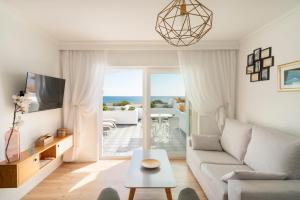 a living room with a couch and a table at La Concha Boutique Apartments - Adults Only in Arrecife