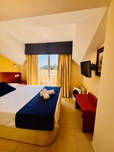a hotel room with a bed with two towels on it at Hotel Atalaya II in Portonovo +74 photos
