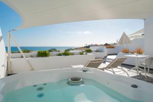 a hot tub in a room with a view of the ocean at La Concha Boutique Apartments - Adults Only in Arrecife