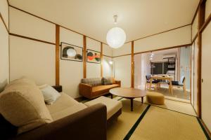 a living room with a couch and a table at Castle Land NAGOYA Family Friendly 5min from Station in Nagoya +49 photos