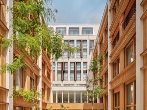 an office building with trees in front of it at TRIBE Paris Pantin in Pantin