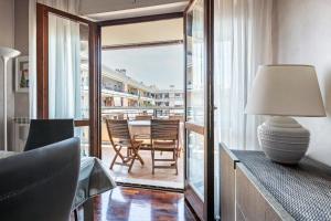 a living room with a table and chairs on a balcony at Fiera Suite Relax in Ponte Galeria