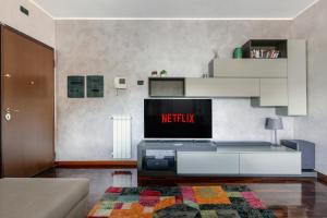 a living room with a tv on a wall at Fiera Suite Relax in Ponte Galeria +15 photos