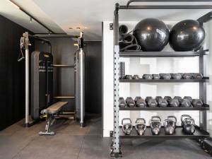 a room with a gym with a bunch of equipment at Athens Capital Suites-MGallery Collection in Athens