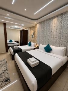 a large bedroom with two beds and a bathroom at Oyal Scarab Pyramids View in Cairo