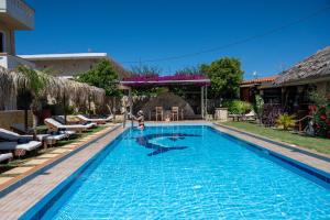 a swimming pool in front of a house at GardenBlue By Gereoudis in Kolymvari