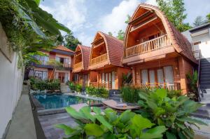 an image of a villa with a swimming pool at Uma Nandhi Villa Ubud in Tegalalang