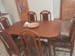 a wooden table with chairs and a plate on it at Pod jedľou in Liptovský Trnovec +8 photos