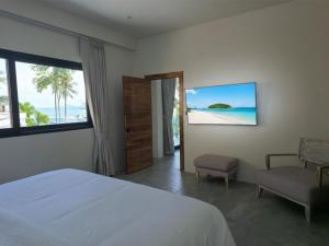 a bedroom with a bed and a view of the ocean at Casa By The Sea in Bangrak Beach +60 photos