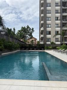 a swimming pool in front of a building at Summers luxury at Bantree in Accra