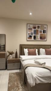 a bedroom with two beds and a mirror at Summers luxury at Bantree in Accra +4 photos