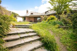 an old house with stairs leading to a yard at Villa Inella in Oggiono +17 photos