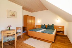 a bedroom with a bed with green pillows on it at Ferienhaus Enzi in Weissbriach +74 photos