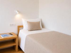 a small bedroom with a bed and a night stand at Princess Palace Monaco in Monte Carlo