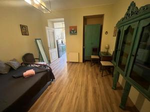 a room with a bed and a table and a desk at One bedroom apartment in Tbilisi City