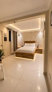 a bedroom with a bed and a white tiled floor at Hotel1325 in Baní +28 photos