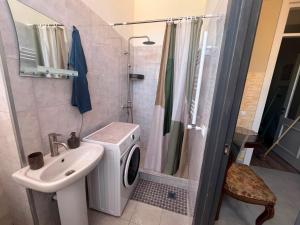 a bathroom with a washing machine and a sink at One bedroom apartment in Tbilisi City