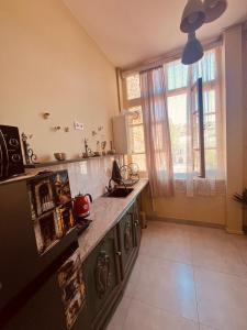 a kitchen with a counter and a large window at One bedroom apartment in Tbilisi City +10 photos