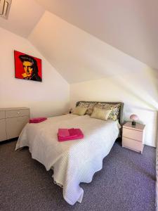 a bedroom with a white bed in a attic at Barevný úlet - Písek in Písek