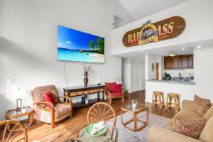 a living room filled with furniture and a flat screen tv at Makani A Kai B11 in Wailuku