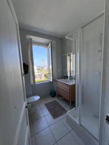 a bathroom with a shower and a toilet and a sink at Ker Lucie in Crozon
