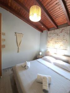a bedroom with a large bed with towels on it at komi's family house in Kómi