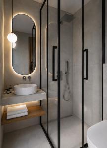 a bathroom with a sink and a shower with a mirror at Harmony Hotel Nafplio in Nafplio +24 photos