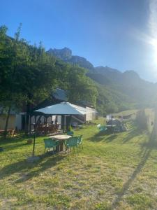 a group of tables and chairs in a field at Guest house Niko in Çerem
