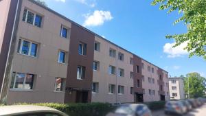 a large brick building on the side of a street at Sigulda's Laimas Apartment Self-Check in in Sigulda