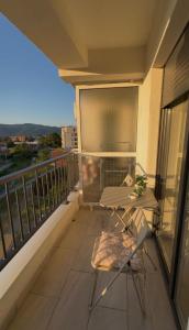 a balcony with a table and chairs on a building at Astera 4 in Vrnjci