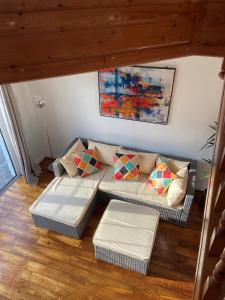 a living room with a couch with pillows at Daline House Clonakilty in Clonakilty