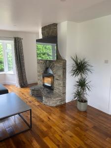 a living room with a stone fireplace at Daline House Clonakilty in Clonakilty
