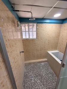 a bathroom with a shower with a tub and a sink at La Casona Guest House in La Unión +18 photos