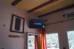a sign on a wall in a room with windows at Auberge Bab chellalat in Tamarout