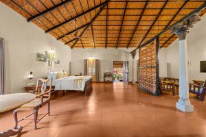 a bedroom with a bed and a wooden ceiling at Magnolia Estates & Resorts in Virajpet