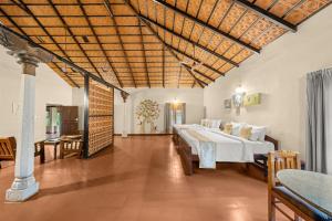 a bedroom with two beds in a room at Magnolia Estates & Resorts in Virajpet +105 photos