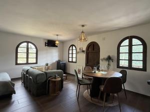 a living room with a couch and a table at uBa Vineyard Stay con vistas al Miño Ribeira Sacra in Chantada