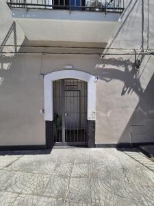 a door to a building with a shadow on the ground at Tommy House CTA in CTA