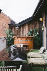 a patio with chairs and a table on a patio at Jason Works in Loughborough