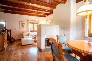 a living room with a table and a fireplace at Haus Uschi in Klagenfurt