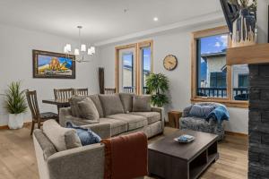 a living room with a couch and a table at Luxury Mountain Haven Views Hot Tub Central Bridgette Bar Main St in Canmore +57 photos